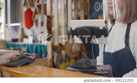 woman using digital wireless or contactless payment using credit card without money for buying coffee 89122201