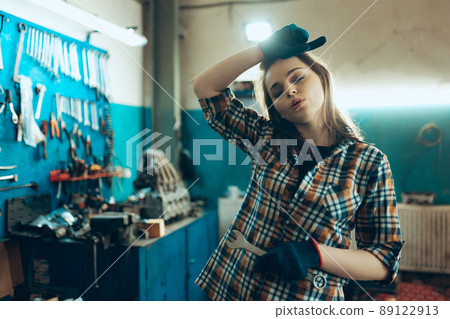 Car reapir, exam. Young pretty girl, auto mechanic working at auto service station using different work tools. Gender equality. Work, occupation, car Car reapir, exam. Young pretty girl, auto mechanic working at auto service station using different work tools. Gender equality. Work, occupation, car 89122913