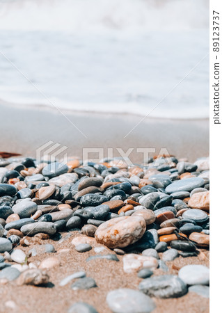 Rock balancing on ocean beach. Pyramid of pebbles on sandy shore. Stable pile or heap in soft focus with bokeh, close up. Zen balance, minimalism, harmony and peace Rock balancing on ocean beach. Pyramid of pebbles on sandy shore. Stable pile or heap in soft focus with bokeh, close up. Zen balance, minimalism, harmony and peace 89123737