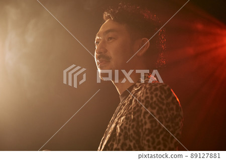 Bearded man in a leopard print jacket singing enthusiastically 89127881