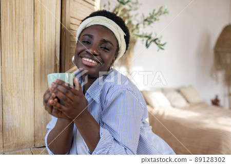 A good-looking african woman in light clothes 89128302
