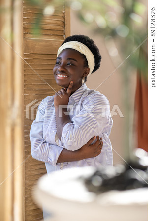 A smiling african american plus size woman looking contented A smiling african american plus size woman looking contented 89128326