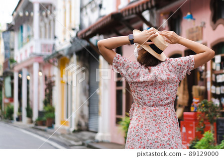 Travelers with mask walking on street Phuket old town with Building Sino Portuguese architecture at Phuket Old Town area Phuket, Thailand. Travel concept and summer trip. 89129000