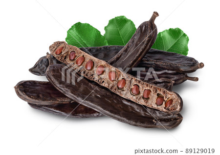 Ripe carob pods and bean isolated on white background with clipping path and full depth of field 89129019