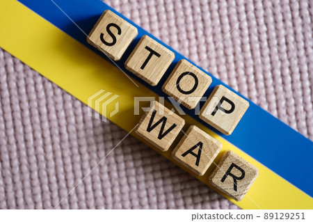 Stop war written on wooden cubes on background of ukrainian flag closeup Stop war written on wooden cubes on background of ukrainian flag closeup 89129251