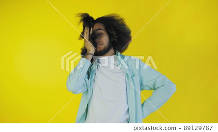 The portrait of a young man making a face gesture, as if there is no, I forgot. An unhappy guy experiencing sadness, regret, drama, failure. Emotions on an orange background. The portrait of a young man making a face gesture, as if there is no, I forgot. An unhappy guy experiencing sadness, regret, drama, failure. Emotions on an orange background. 89129787