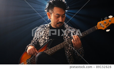 Bearded man in a leopard print jacket playing the base 89132828