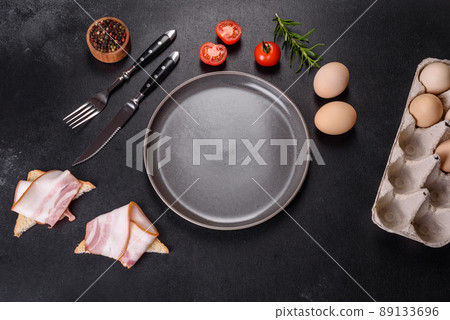 A delicious nutritious healthy breakfast with fried eggs, bacon, beans, a glass of juice, oat cookies, milk and jam A delicious nutritious healthy breakfast with fried eggs, bacon, beans, a glass of juice, oat cookies, milk and jam 89133696