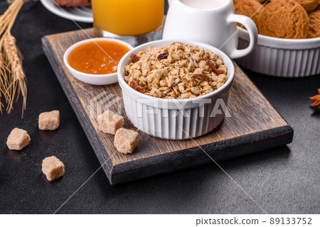 Delicious nutritious healthy breakfast with granola, eggs, oat cookies, milk and jam Delicious nutritious healthy breakfast with granola, eggs, oat cookies, milk and jam 89133752
