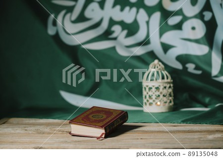 Sacred book of Quran on a wooden surface. Sacred book of Quran on a wooden surface. 89135048