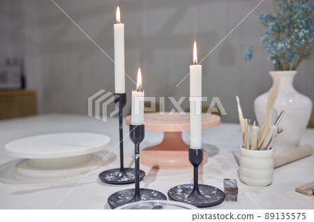 Three candles on the small table covered. Three candles on the small table covered. 89135575