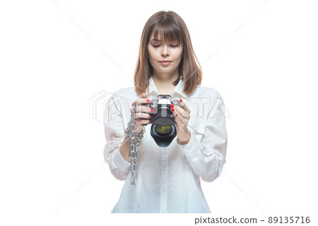 Copyright. The camera is chained to the photographer's hand. The concept of protecting the photographer from theft of his photos. Isolated on white background. 89135716
