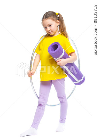 Little cute girl with hula hoop and gym mat. Isolated on white background. 89135718