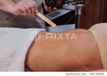 procedure removing cellulite on female abdomen, cavitation belly massage. Ultrasonic massage for weight loss. Correction of female figure without surgical intervention. Closeup of the tummy. procedure removing cellulite on female abdomen, cavitation belly massage. Ultrasonic massage for weight loss. Correction of female figure without surgical intervention. Closeup of the tummy. 89136862