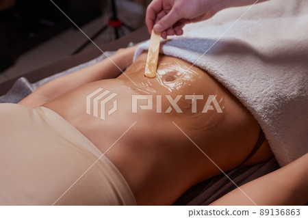 procedure removing cellulite on female abdomen, cavitation belly massage. Ultrasonic massage for weight loss. Correction of female figure without surgical intervention. Closeup of the tummy. procedure removing cellulite on female abdomen, cavitation belly massage. Ultrasonic massage for weight loss. Correction of female figure without surgical intervention. Closeup of the tummy. 89136863