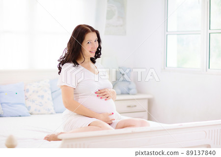 Pregnant woman at home. Young expecting mother. 89137840