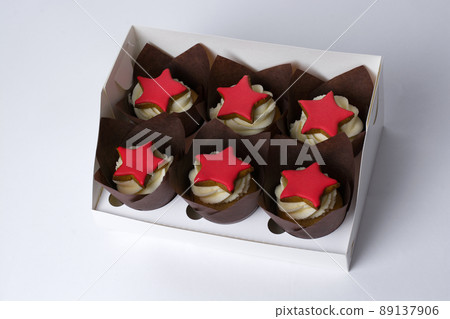 cupcakes with cream and red stars on a white background 89137906