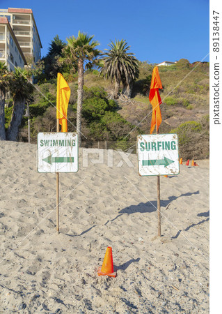 Surfing and swimming signboard at the beach in San Clemente, California 89138447