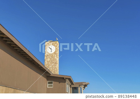 Tower with stone sidings and clock on top of a building at San Clemente, California 89138448
