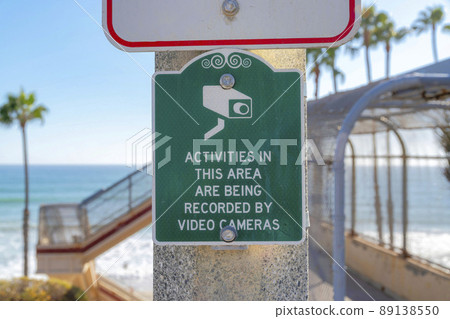 Security camera signage against the footbridge and ocean in San Clemente, California 89138550