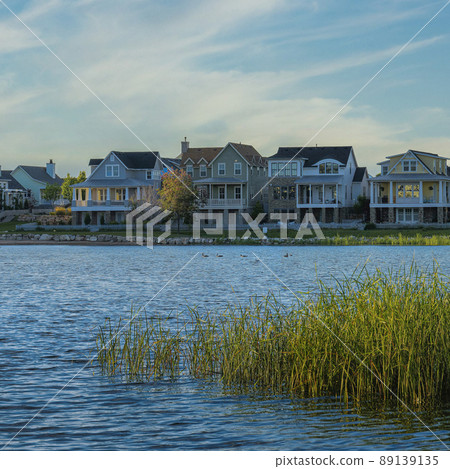 Square Whispy white clouds Oquirrh Lake waterfront during sunset at Daybreak, Utah 89139135