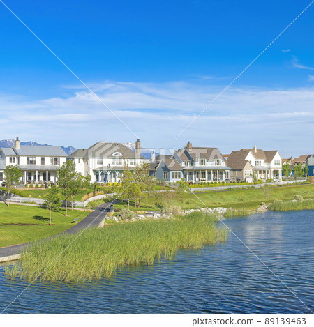Square Whispy white clouds Panoramic view of a peaceful residential area at Daybreak, Utah 89139463
