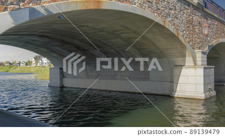 Panorama Whispy white clouds Double arched bridge with stone walls and railings over the Oqui 89139479