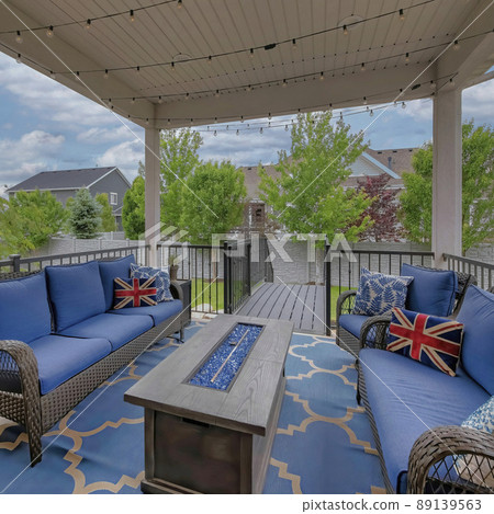 Square White puffy clouds Cozy outdoor deck with fire pit table and woven sofas with blue Square White puffy clouds Cozy outdoor deck with fire pit table and woven sofas with blue 89139563