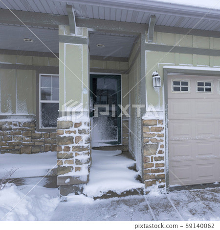 Square Exterior of a house with two garage doors and stone bricks siding Square Exterior of a house with two garage doors and stone bricks siding 89140062