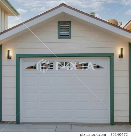 Square White puffy clouds Detached garage in between two white buildings at Oceanside, Cal 89140472