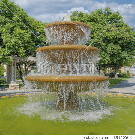 Square White puffy clouds Water fountain in the middle of a community plaza at San Marcos, Square White puffy clouds Water fountain in the middle of a community plaza at San Marcos, 89140508