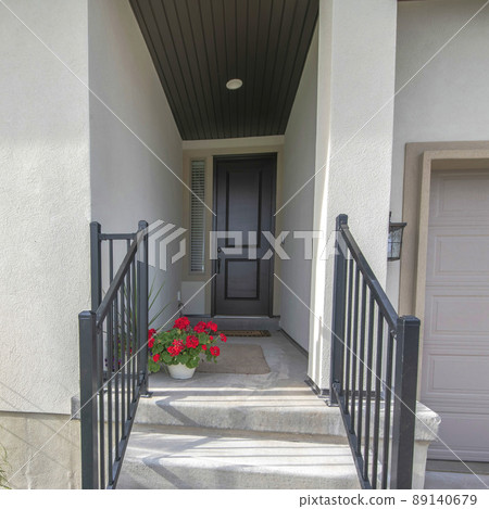 Square Entrance of a house in the middle of the walls with stairs and railings 89140679