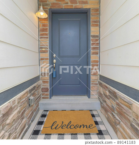 Square Small home entrance in the middle of the wall with beige wood vinyl and stone veneer sidings 89141183