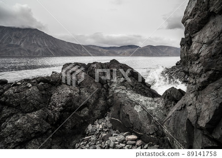 Rocky sea coast. View of the rocks and mountains on the shore of the sea bay. 89141758