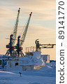 Winter view of the cranes of a small cargo seaport in the far north of Russia in the Arctic 89141770