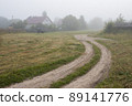 View of a deserted village street and an old wooden house 89141776