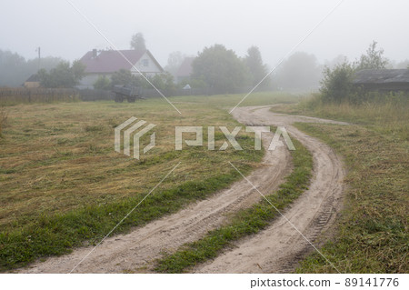 View of a deserted village street and an old wooden house 89141776