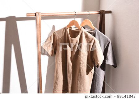 A plain T-shirt on a hanger rack in the sun A plain T-shirt on a hanger rack in the sun 89141842