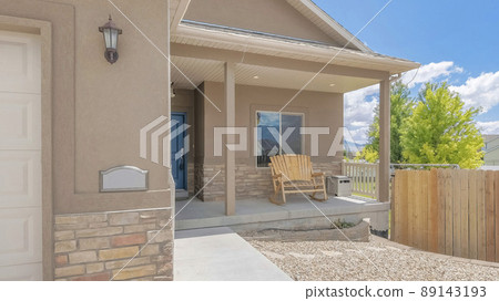 Panorama White puffy clouds Outside the residential house with wooden fence and gravel at the front yard 89143193