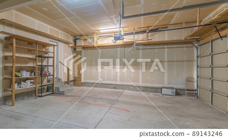 Panorama Large garage interior with wall filler white markings and shelves 89143246