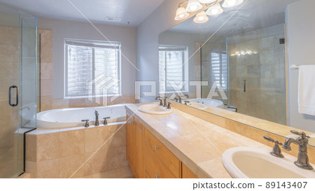 Panorama Master bathroom interior with antique faucet fixtures and warm colored tiles 89143407