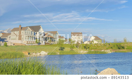 Panorama White puffy clouds Panoramic view of blue waters of Oquirrh Lake at Daybreak in South Jordan, California 89143513
