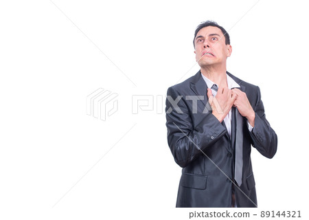 Weary businessman loosening tie in light studio Weary businessman loosening tie in light studio 89144321