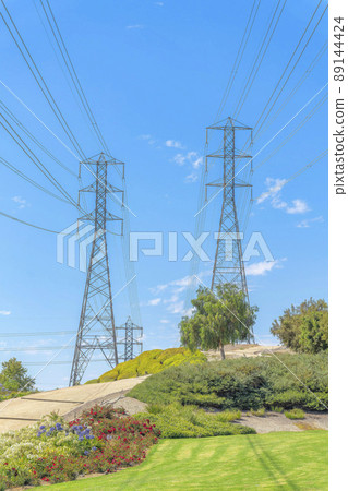 Transmission towers with power line cables on a field at Ladera Ranch in California Transmission towers with power line cables on a field at Ladera Ranch in California 89144424