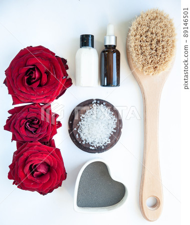 Flat lay organic, bio, natural cosmetics.  Remedy for massage, spa.  Roses , Natural oils and massage brush, blue clay 89146501