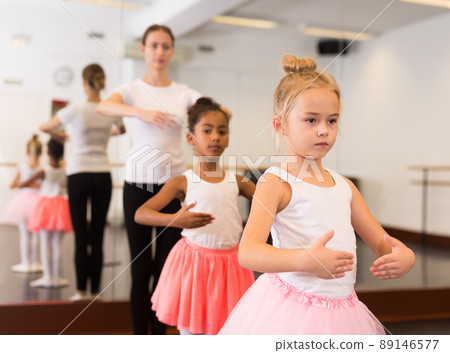 Dance teacher helping her little girls students Dance teacher helping her little girls students 89146577