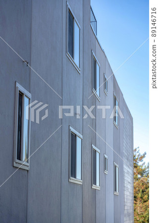 Dark gray building exterior with sliding glass window at San Francisco, California 89146716