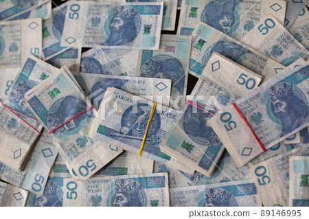 A file of banknotes lies on a scattering of fifty Polish zloty bills. A file of banknotes lies on a scattering of fifty Polish zloty bills. 89146995