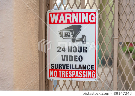 Surveillance camera signage on a metal mesh wire railings at San Francisco, California Surveillance camera signage on a metal mesh wire railings at San Francisco, California 89147243
