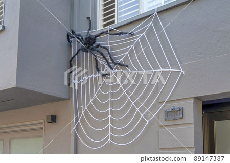 Black plush spider on a house at San Francisco, California 89147387